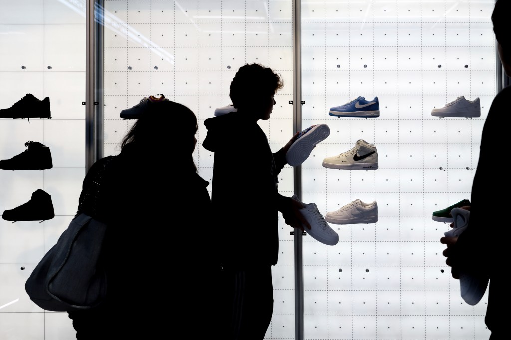 People buy shoes at a Nike store on November 25, 2022 in New York.