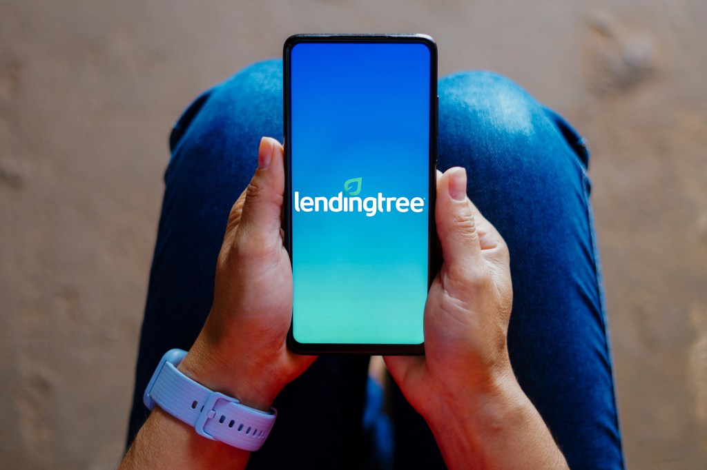 In this photographic illustration, the lendingree logo is displayed on the smartphone screen.