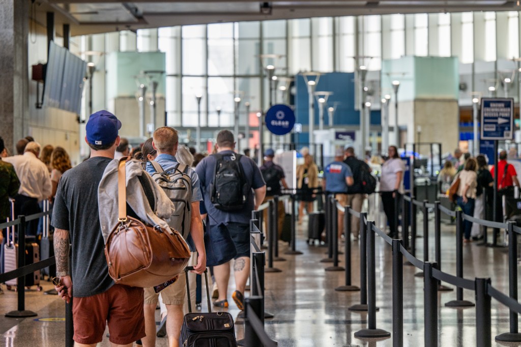 Passengers waiting online at the airport safety.